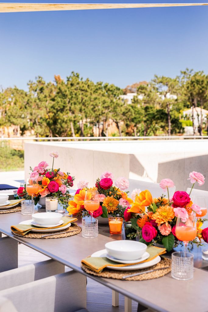 Exterior rooftop dining with bright floral arrangement and decor