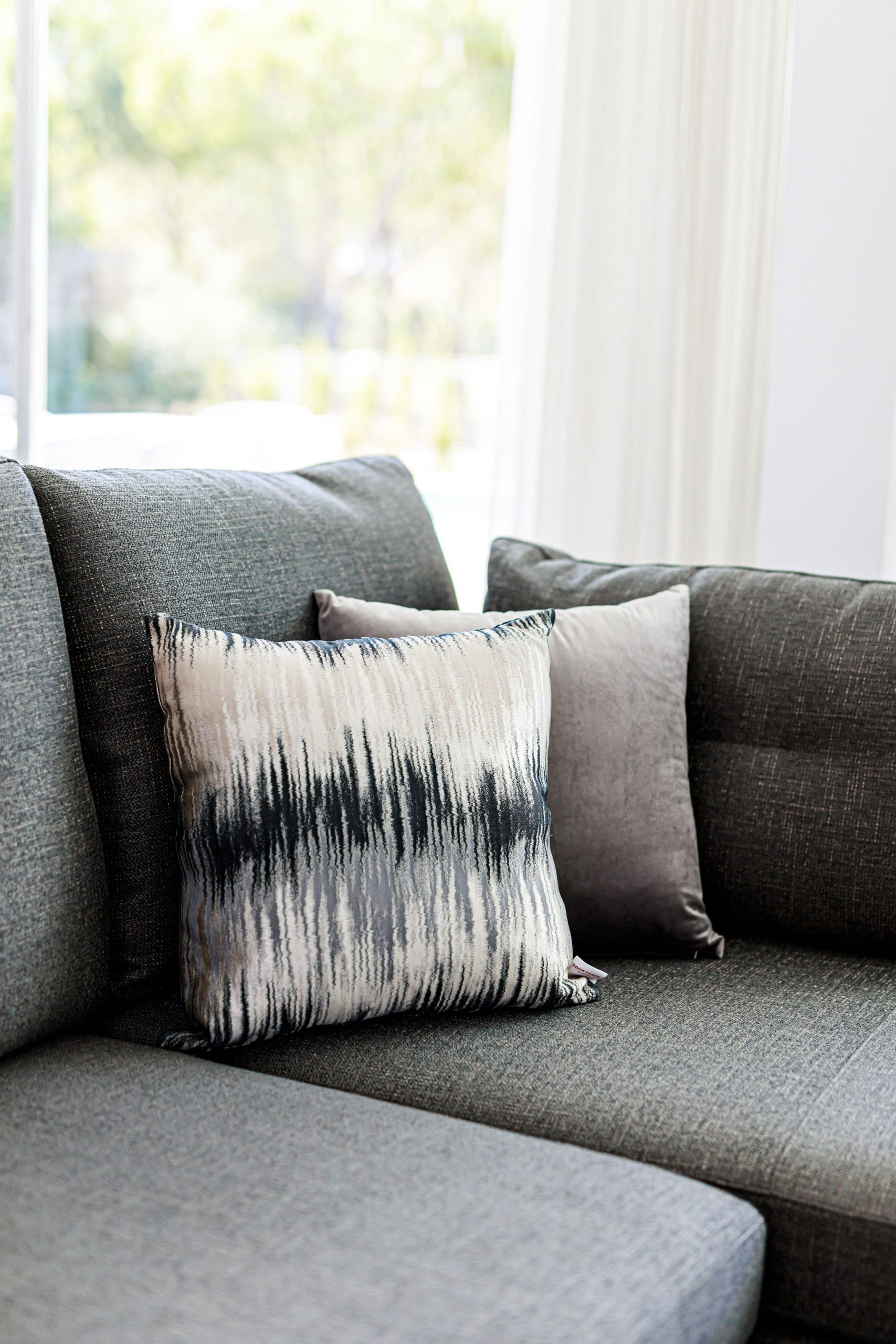 Bespoke textured grey sofa with black cushions
